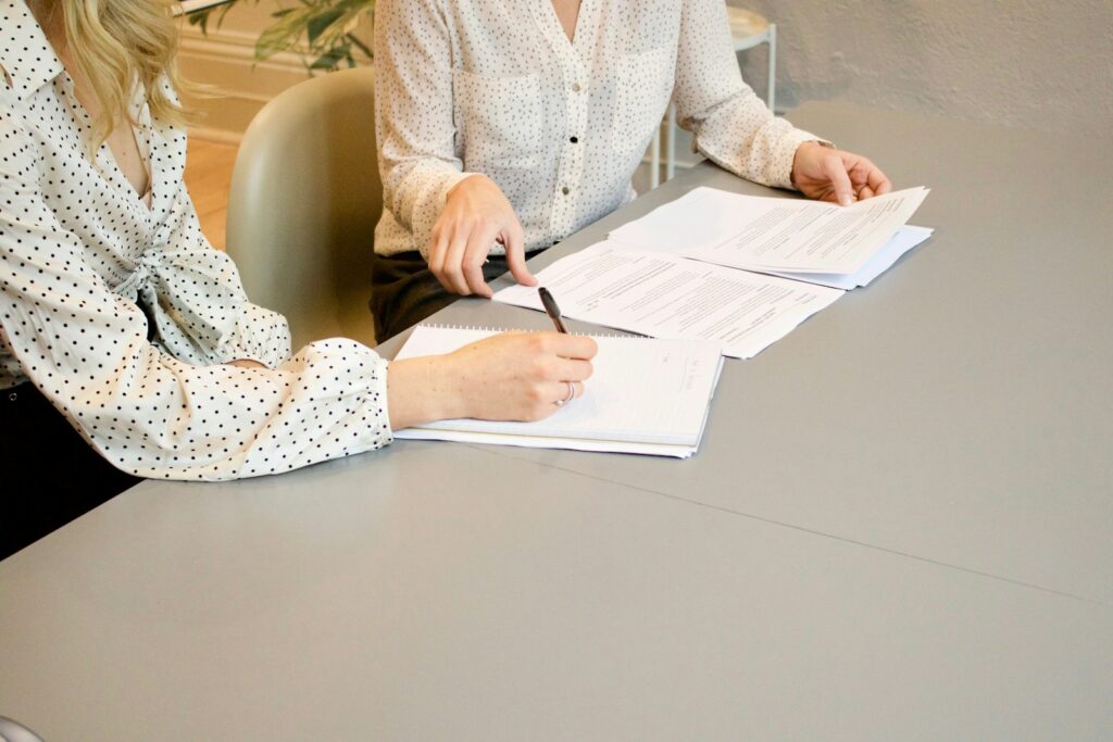 Client signing documents during a consultation with a family lawyer