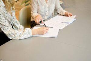 Client signing documents during a consultation with a family lawyer