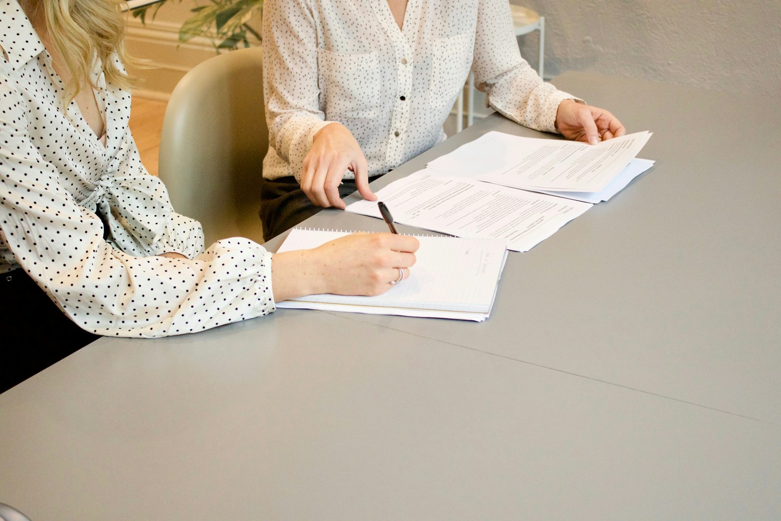 Client signing documents during a consultation with a family lawyer
