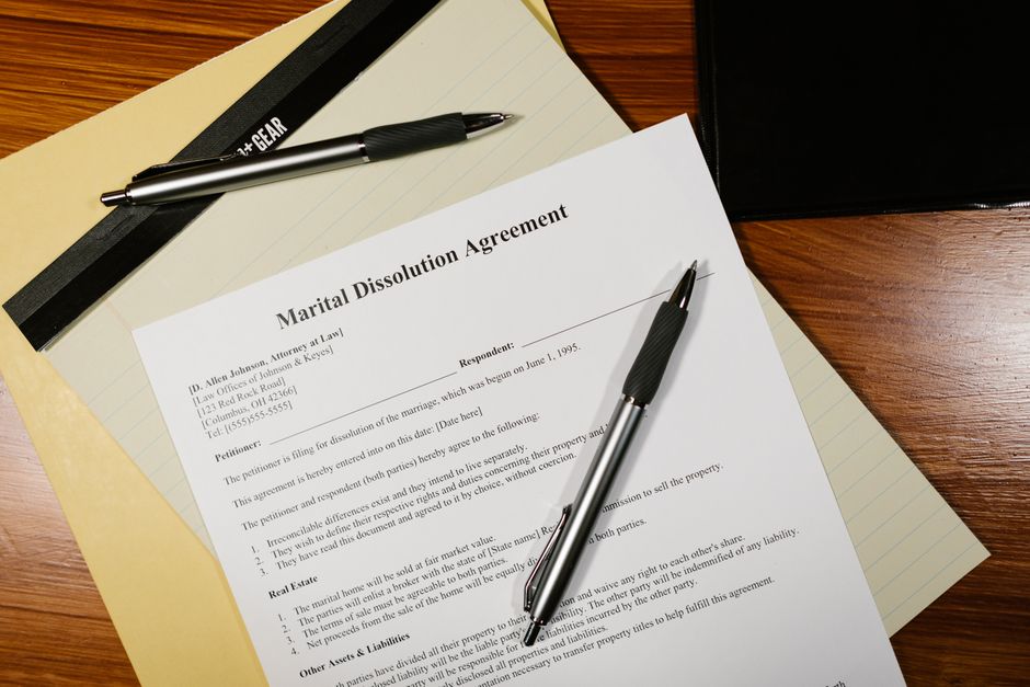 Close-up of family law documents being signed with a pen